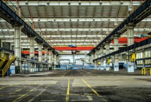 Expansive industrial warehouse interior showcasing steel framework and spacious layout for diverse manufacturing needs.